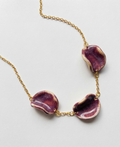Akti plum ceramic necklace with gold chain, handmade organic petal forms in natural light and shadow