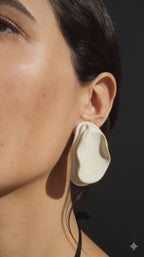 Anthi white ceramic statement earrings, handmade folded petal forms in natural light and shadow