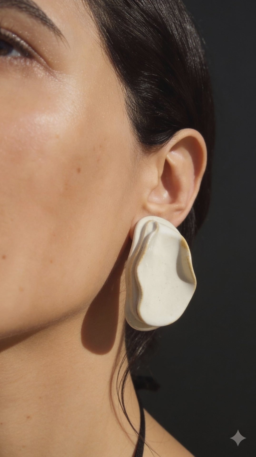 Anthi white ceramic statement earrings, handmade folded petal forms in natural light and shadow
